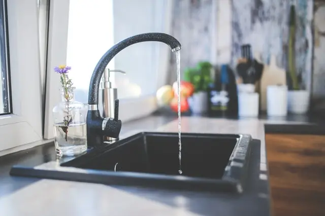 Kitchen sink and black faucet