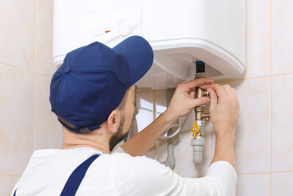 Keeping Your Instant Water Heater in Good ShapeKeeping Your Instant Water Heater in Good Shape Licensed plumber inspecting and cleaning an instant water heater in a modern bathroom