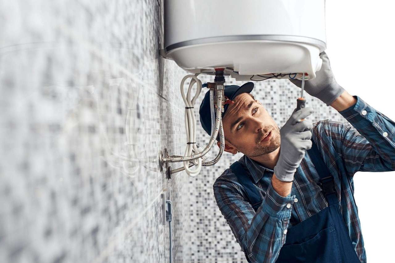 a plumber fixing a water heater